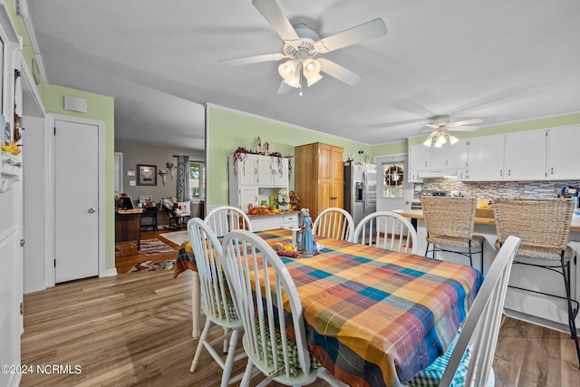 dining space with ceiling fan and hardwood / wood-style floors