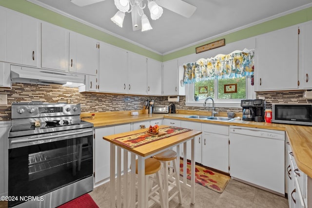 kitchen featuring ceiling fan, sink, white cabinetry, appliances with stainless steel finishes, and crown molding