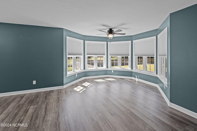 empty room featuring ceiling fan and hardwood / wood-style flooring