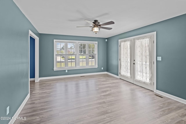 spare room featuring ceiling fan and light hardwood / wood-style flooring