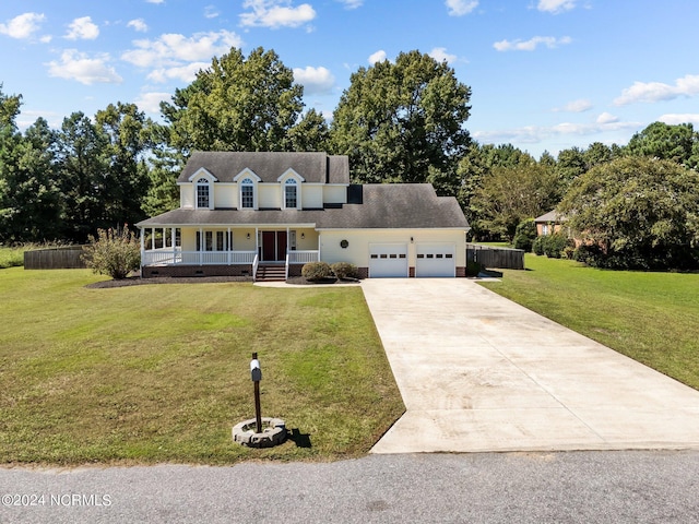 view of front of house with covered porch, a front yard, and a garage