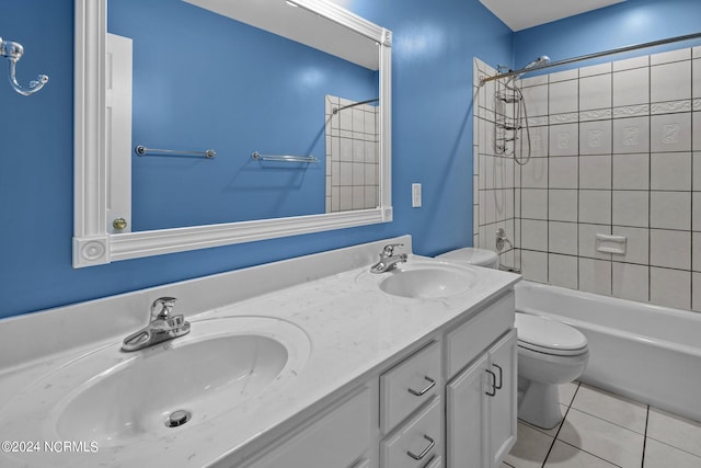 full bathroom featuring vanity, toilet, tile patterned floors, and tiled shower / bath