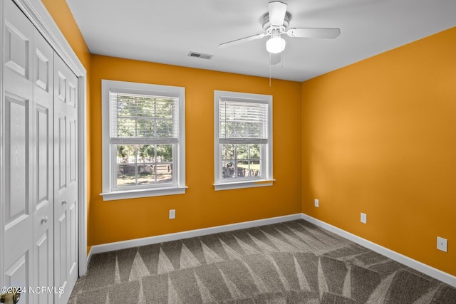 unfurnished bedroom featuring carpet floors, ceiling fan, and a closet