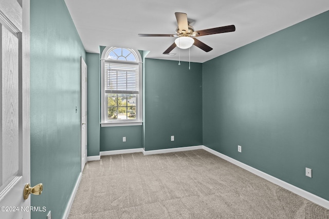 carpeted empty room with ceiling fan