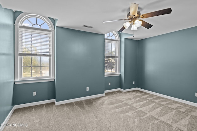 unfurnished room with carpet flooring and ceiling fan