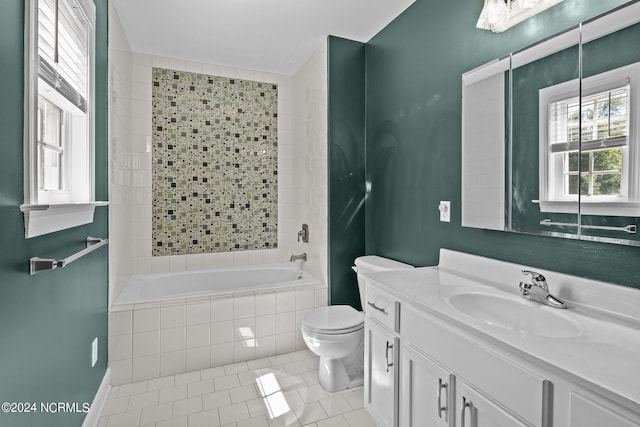 full bathroom with tiled shower / bath combo, vanity, tile patterned flooring, and toilet