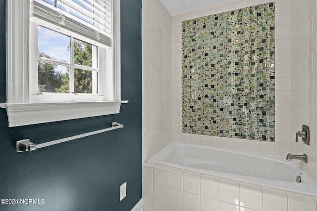 bathroom featuring a relaxing tiled tub