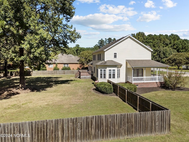 back of house with a yard