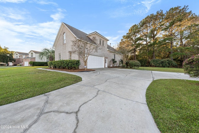 view of side of home with a lawn and a garage