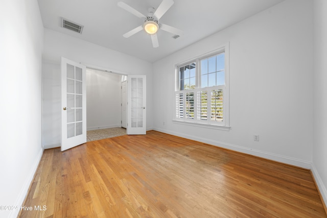 unfurnished bedroom with ceiling fan, light hardwood / wood-style floors, and french doors