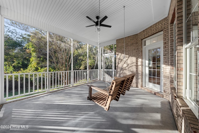 unfurnished sunroom featuring a wealth of natural light and ceiling fan