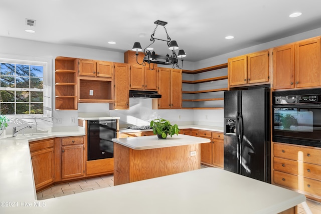 kitchen with black appliances, sink, hanging light fixtures, a notable chandelier, and a kitchen island