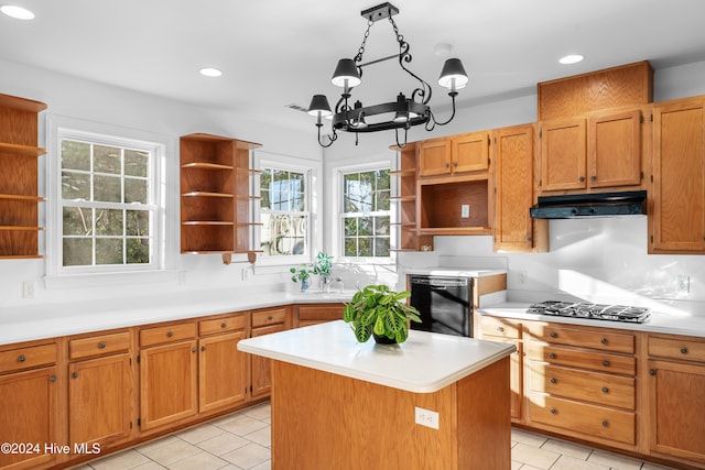 kitchen featuring dishwasher, a center island, decorative light fixtures, stainless steel gas cooktop, and a chandelier