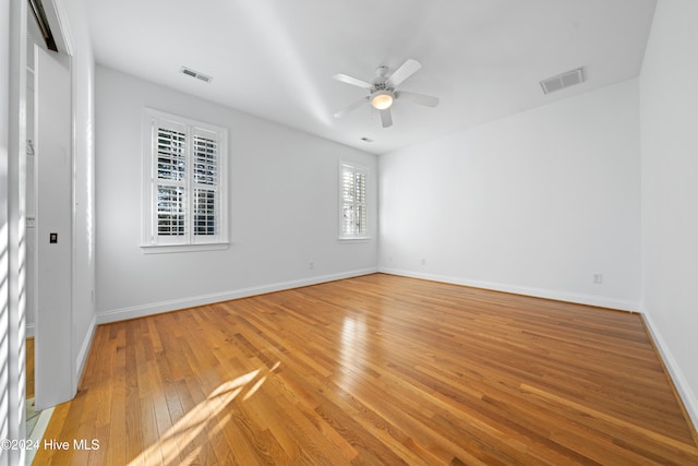 spare room featuring light wood-type flooring and ceiling fan