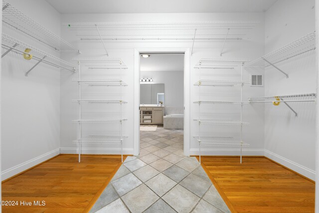 spacious closet with hardwood / wood-style floors