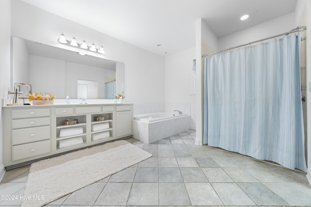 bathroom featuring vanity and tiled bath