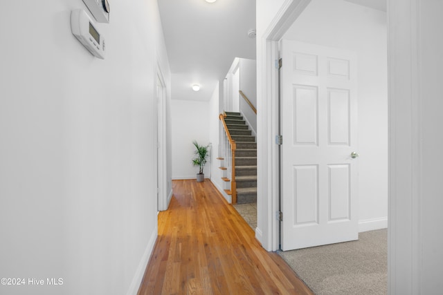 corridor with light hardwood / wood-style flooring