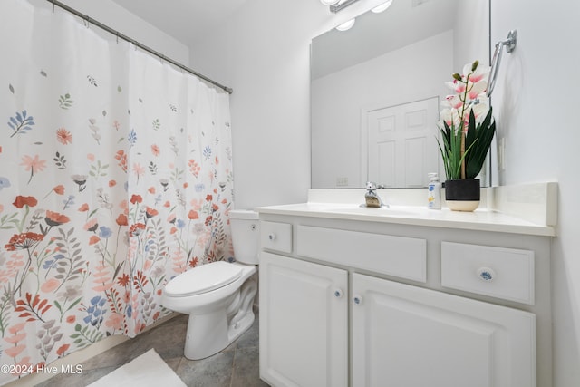 bathroom with tile patterned floors, vanity, curtained shower, and toilet