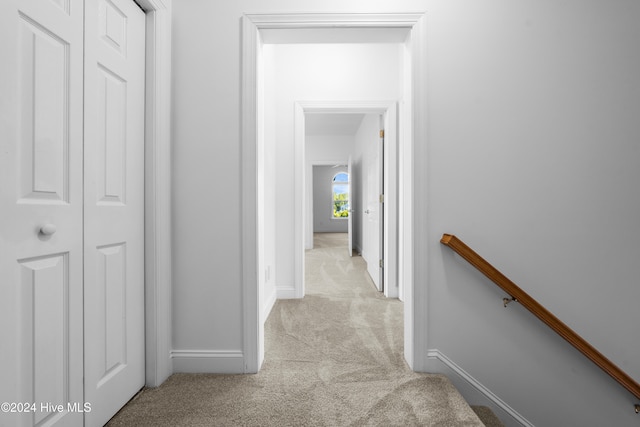 corridor with light colored carpet