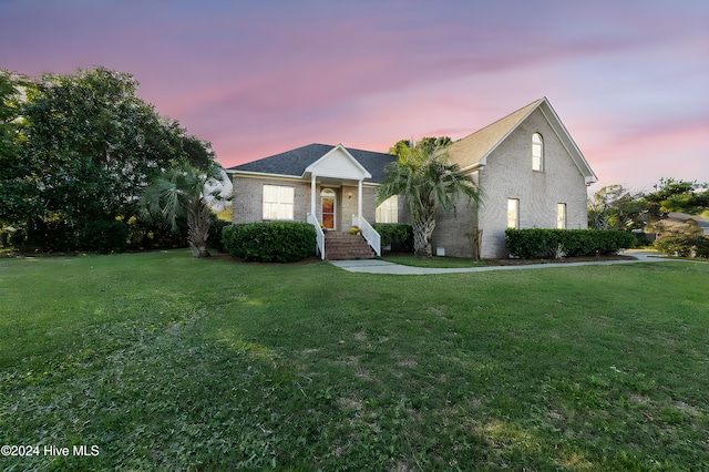 view of front of property with a yard