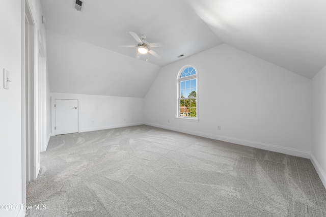 additional living space featuring light carpet, ceiling fan, and lofted ceiling