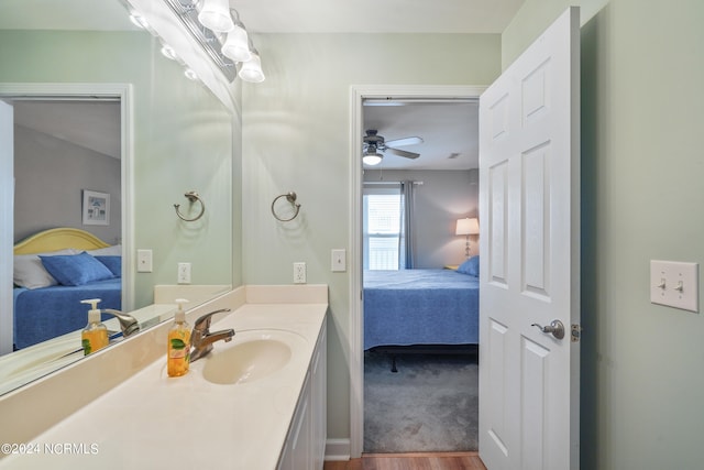 bathroom featuring hardwood / wood-style floors, vanity, and ceiling fan