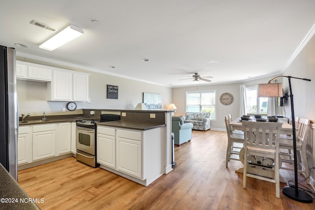 kitchen with white cabinets, light hardwood / wood-style floors, crown molding, and appliances with stainless steel finishes