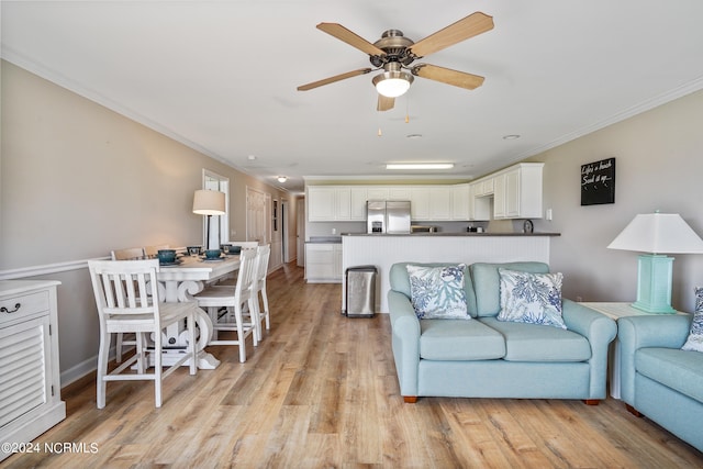 living room with ceiling fan, crown molding, and light hardwood / wood-style flooring