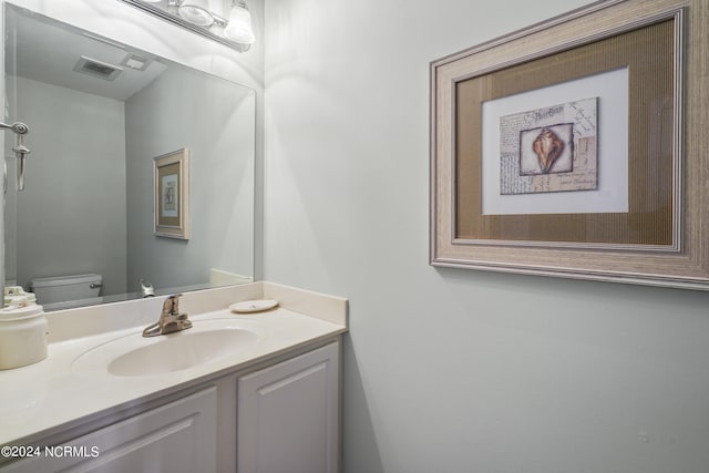 bathroom with vanity and toilet