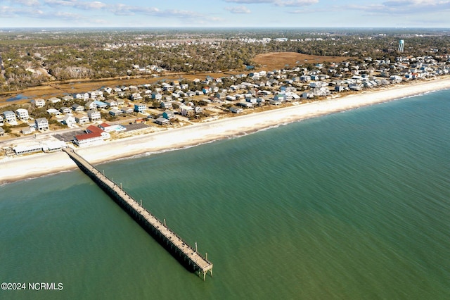 bird's eye view featuring a water view and a beach view