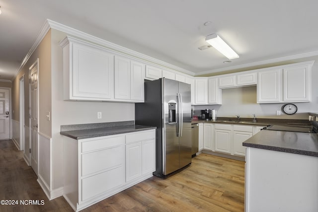 kitchen featuring appliances with stainless steel finishes, light wood-type flooring, crown molding, sink, and white cabinets