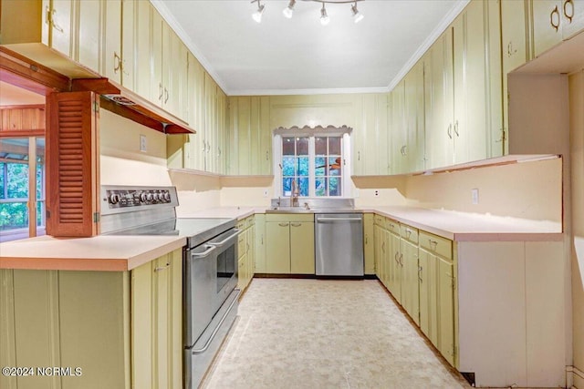 kitchen with appliances with stainless steel finishes, crown molding, sink, and rail lighting