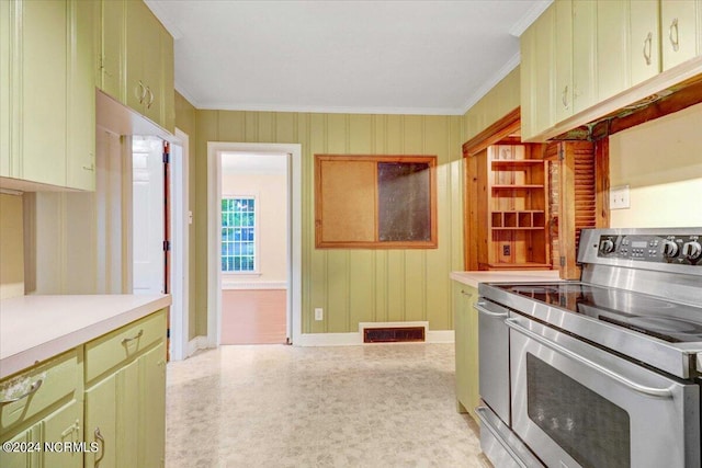 kitchen with ornamental molding, green cabinets, and stainless steel electric stove