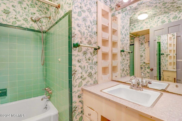 bathroom with tiled shower / bath combo and vanity