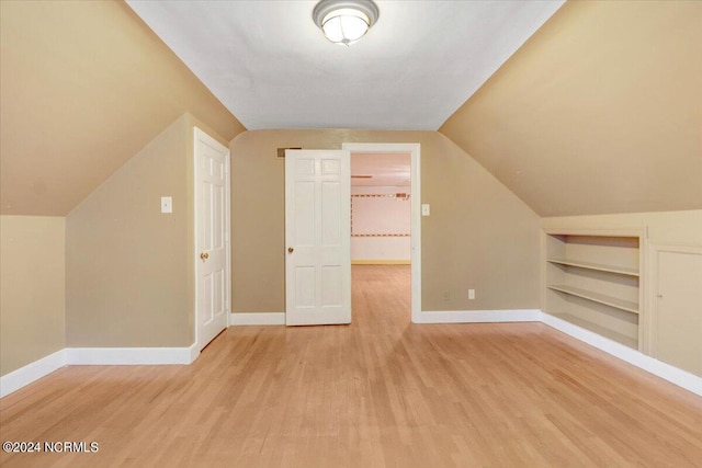 bonus room with light hardwood / wood-style flooring and vaulted ceiling