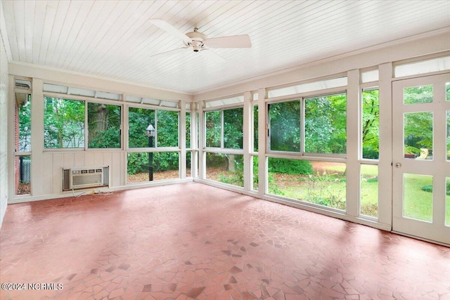 unfurnished sunroom featuring ceiling fan and a wall unit AC