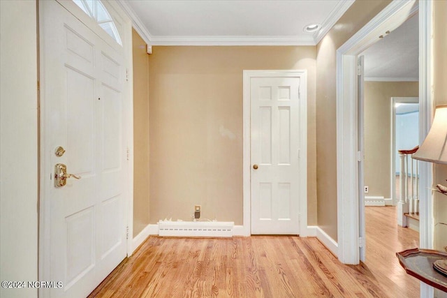 entryway with ornamental molding and light hardwood / wood-style floors