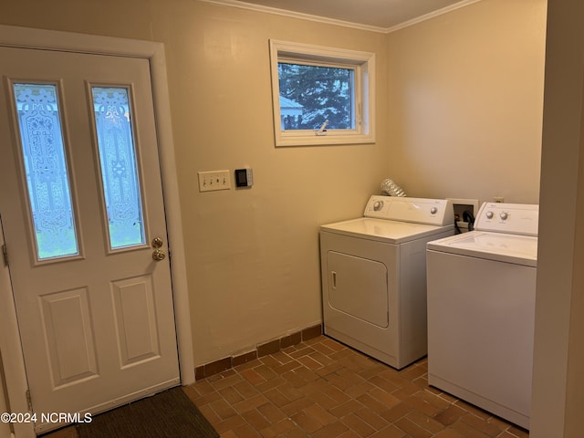 clothes washing area with ornamental molding and separate washer and dryer