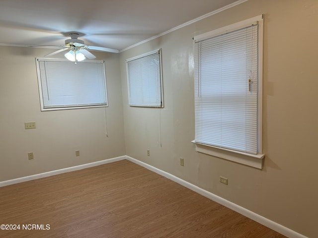 spare room with ceiling fan, hardwood / wood-style floors, and crown molding