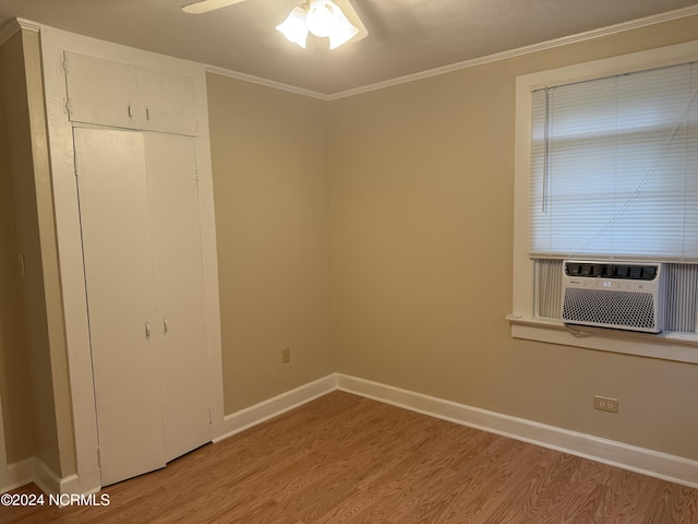 unfurnished bedroom with ceiling fan, cooling unit, light hardwood / wood-style flooring, and crown molding