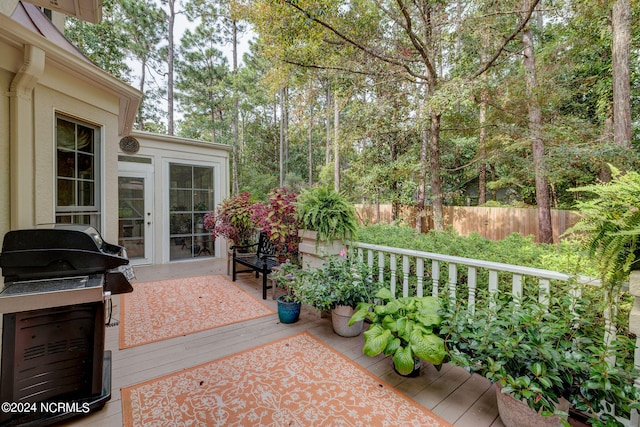 view of patio featuring a wooden deck, a grill, and french doors