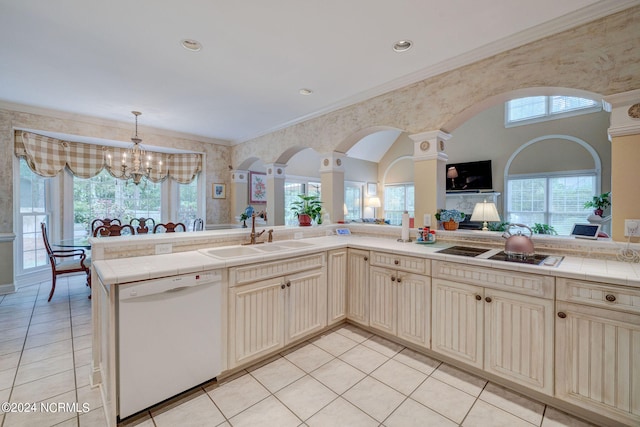 kitchen featuring a notable chandelier, dishwasher, a healthy amount of sunlight, and sink