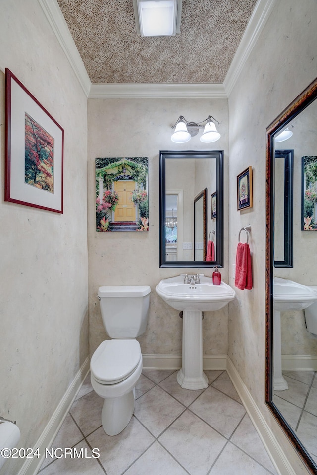 bathroom with crown molding, toilet, and tile patterned floors