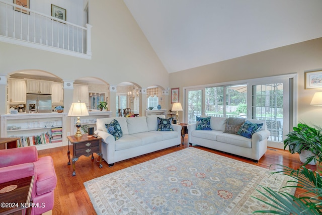 living room featuring light hardwood / wood-style floors and high vaulted ceiling