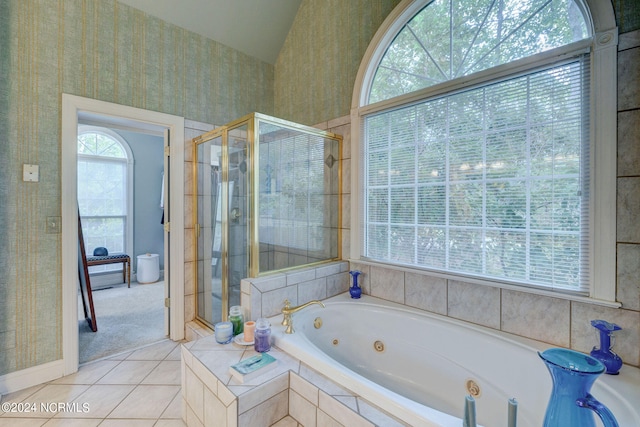 bathroom featuring independent shower and bath, lofted ceiling, and tile patterned floors