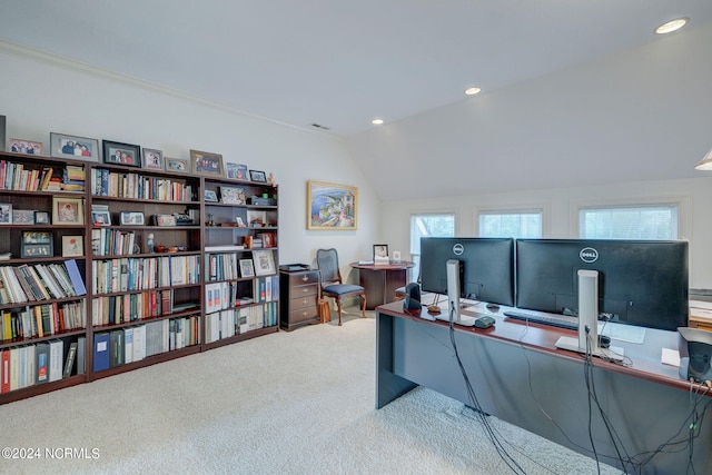 carpeted office space featuring vaulted ceiling