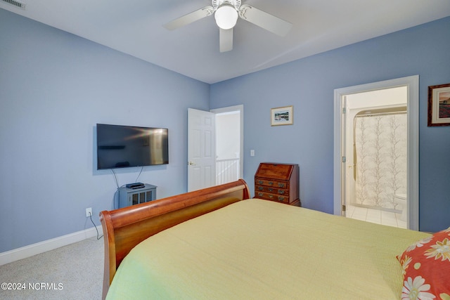 carpeted bedroom featuring ceiling fan and ensuite bathroom