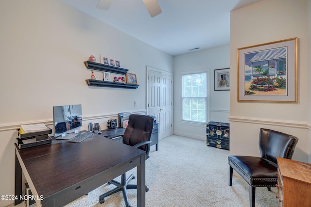 office space featuring carpet flooring, visible vents, and ceiling fan