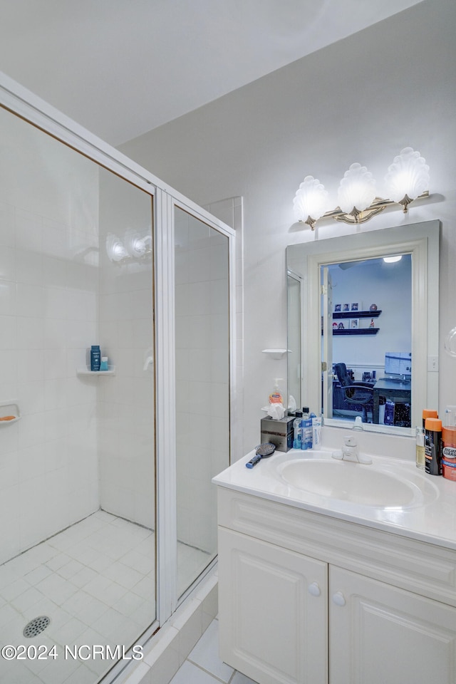 bathroom with vanity, an enclosed shower, and tile patterned floors