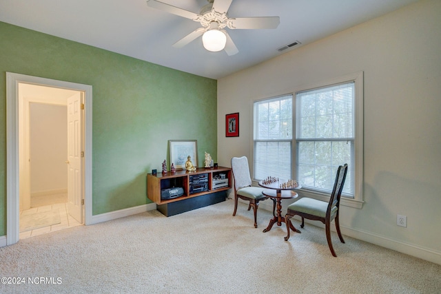 sitting room with carpet flooring and ceiling fan